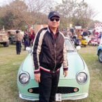 Khurram standing in front of his Figaro