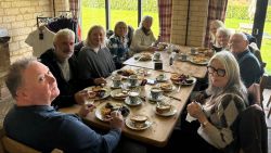 Club members dining together round a table
