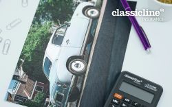 a picture of a Figaro with a pen, paper and calculator to the side