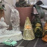 a nativity scene with a model nissan figaro parked in front