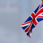 A UK and US flag stood next to each other