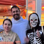 Marius and Tobyn from Figaro Shop standing with some club members in front of Figaro Owners Club banner