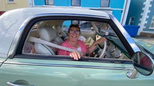 A beaming driver in a Nissan FIgaro