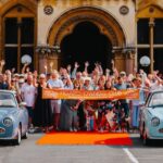 Members stood outside the hall, waving at the Big Birthday Bash