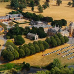 A drone shot of Nissan Figaros parked up at the Big Birthday Bash at Walton Hall