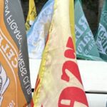 Lots of flags on a Nissan Figaro